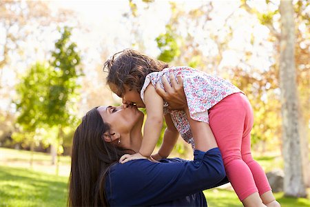 simsearch:400-04045907,k - Mixed race Asian mum kissing her young daughter in park Stock Photo - Budget Royalty-Free & Subscription, Code: 400-08839612