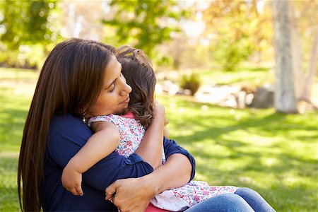 simsearch:400-04045907,k - Mixed race Asian mum embracing her young daughter in a park Stock Photo - Budget Royalty-Free & Subscription, Code: 400-08839613
