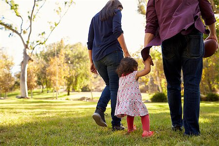 father and daughter of backside in garden - Couple walking in park with their young daughter, back view Stock Photo - Budget Royalty-Free & Subscription, Code: 400-08839670