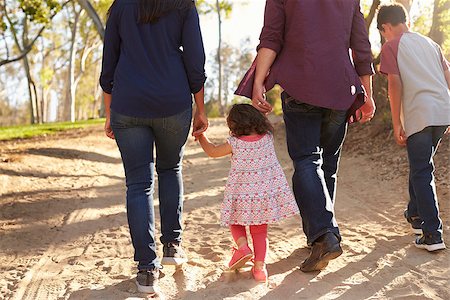 Mixed race family walking on a rural path, back view, crop Stock Photo - Budget Royalty-Free & Subscription, Code: 400-08839682