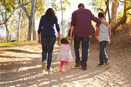 Mixed race family walking on rural path, close up back view Stock Photo - Budget Royalty-Free & Subscription, Code: 400-08839683