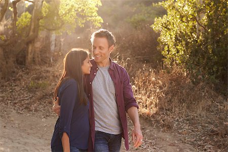 Mixed race couple walking in park embracing, waist up Stock Photo - Budget Royalty-Free & Subscription, Code: 400-08839692