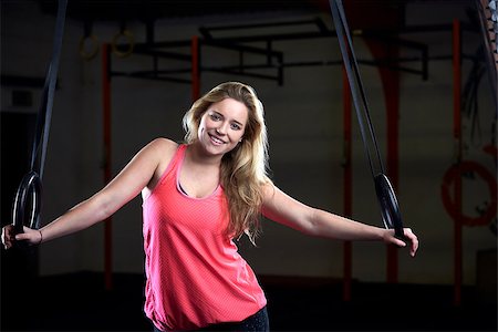 Portrait Of Young Woman In Gym With Olympic Rings Stock Photo - Budget Royalty-Free & Subscription, Code: 400-08839758
