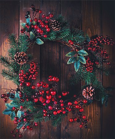 Christmas wreath decoration with pine cones and hawthorn berries on wooden background Stock Photo - Budget Royalty-Free & Subscription, Code: 400-08831216