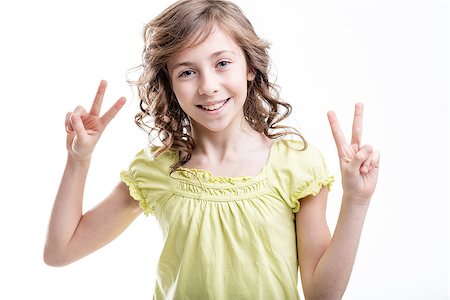 simsearch:400-08831347,k - sunny cheerful girl showing a couple of v-signs about peace or victory wearing a yellowish green lovely dress Stock Photo - Budget Royalty-Free & Subscription, Code: 400-08831344