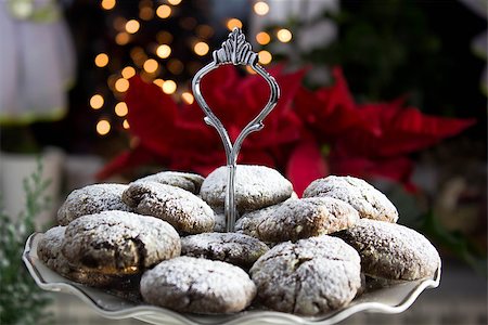 family eating light - Christmas chocolate cookies with poinsettia in the background Stock Photo - Budget Royalty-Free & Subscription, Code: 400-08831589