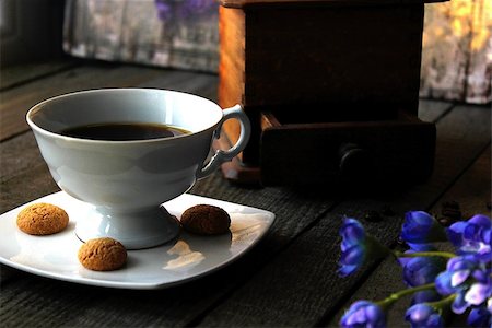 A white cup of coffee with amaretti on the side, blue flowers on the table Stock Photo - Budget Royalty-Free & Subscription, Code: 400-08831592