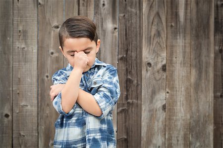 racing fences - Young Frustrated Mixed Race Boy With Hand on Face Against Wooden Fence. Stock Photo - Budget Royalty-Free & Subscription, Code: 400-08832105