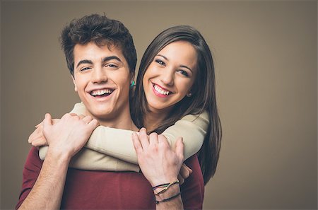 Happy young loving couple hugging and smiling at camera Stock Photo - Budget Royalty-Free & Subscription, Code: 400-08832163