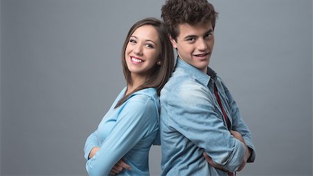 Young happy couple back to back smiling at camera Stock Photo - Budget Royalty-Free & Subscription, Code: 400-08832180
