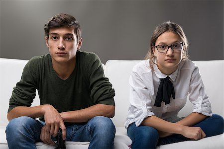 sibling sad - portrait of serious couple of kids that could be brothers or friends but they are a young man and a young woman Stock Photo - Budget Royalty-Free & Subscription, Code: 400-08832310