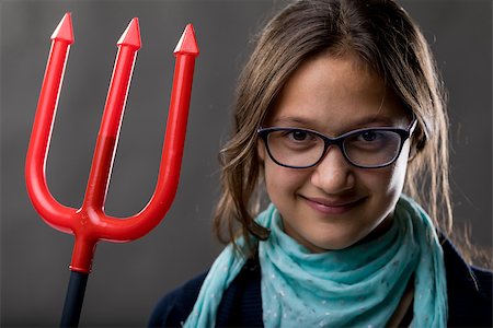 portrait of a little rascal girl with a red pitchfork meaning she is a little devil ready to make some pranks and jokes to have some fun Stock Photo - Budget Royalty-Free & Subscription, Code: 400-08832313