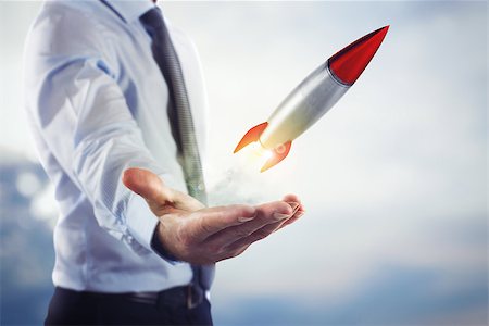 simsearch:400-09112433,k - Businessman holding a small rocket. Startup working enterprise concept Stockbilder - Microstock & Abonnement, Bildnummer: 400-08832990