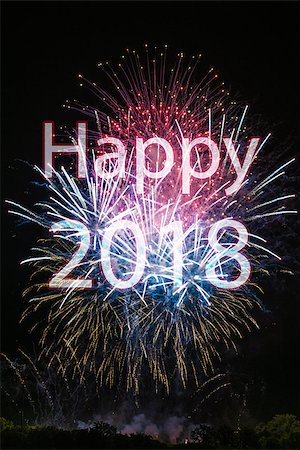 franky242 (artist) - Happy New Year 2018 with colorful sparklers. The words Happy 2018 are integrated into the fireworks on black background with trees at the bottom Fotografie stock - Microstock e Abbonamento, Codice: 400-08833027