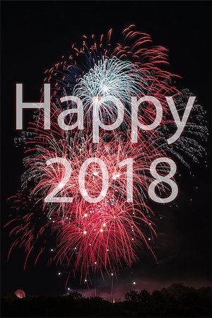 franky242 (artist) - Happy New Year 2018 with colorful sparklers. The words Happy 2018 are integrated into the fireworks on black background with trees at the bottom Fotografie stock - Microstock e Abbonamento, Codice: 400-08833029