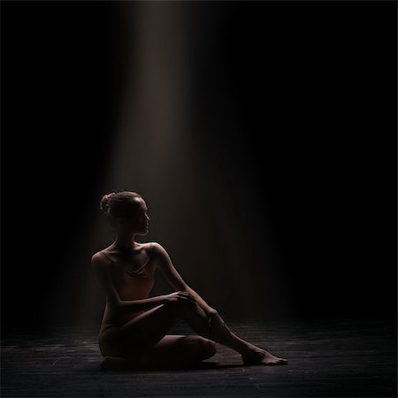 simsearch:400-04924214,k - silhouette of beautiful woman ballet dancer sitting on wooden floor over dark background Stock Photo - Budget Royalty-Free & Subscription, Code: 400-08864150