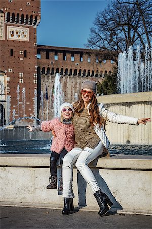 simsearch:400-08864986,k - Rediscovering things everybody love in Milan. Full length portrait of smiling modern mother and child tourists in sunglasses near Sforza Castle in Milan, Italy having fun time Stock Photo - Budget Royalty-Free & Subscription, Code: 400-08864694
