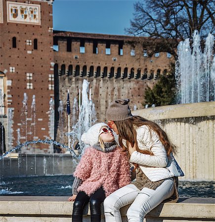 simsearch:400-08864986,k - Rediscovering things everybody love in Milan. Full length portrait of happy modern mother and daughter tourists in sunglasses near Sforza Castle in Milan, Italy kissing Stock Photo - Budget Royalty-Free & Subscription, Code: 400-08864695