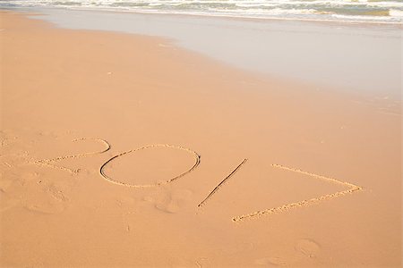 2017 text hand writing on sand beach at the sea Stock Photo - Budget Royalty-Free & Subscription, Code: 400-08864739