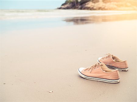 simsearch:400-09237669,k - Yellow canvas shoes on the sand beach in vintage filter tone and light effect Stock Photo - Budget Royalty-Free & Subscription, Code: 400-08864740