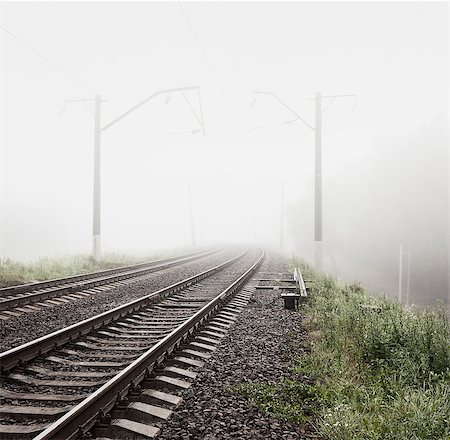 simsearch:400-05883568,k - Railway in Fog. Misty Morning Landscape. Empty Railroad. Toned and Filtered Photo with Copy Space. Mystical Nature Background. Photographie de stock - Aubaine LD & Abonnement, Code: 400-08864890