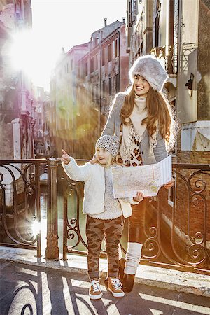 simsearch:400-07954337,k - Venice. Off the Beaten Path. Full length portrait of happy young mother and child tourists in Venice, Italy in the winter with map Stock Photo - Budget Royalty-Free & Subscription, Code: 400-08864989