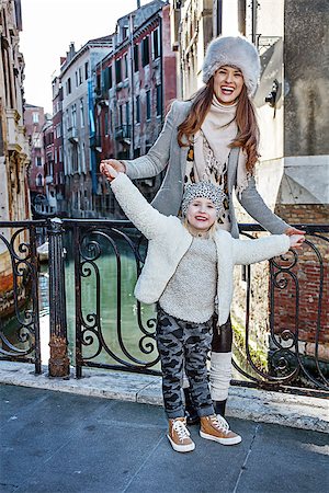 simsearch:400-07954337,k - Venice. Off the Beaten Path. Full length portrait of smiling modern mother and daughter tourists in Venice, Italy in the winter having fun time Stock Photo - Budget Royalty-Free & Subscription, Code: 400-08864982
