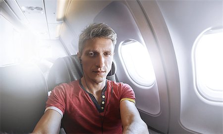 man photographer taking selfie in the airplane Fotografie stock - Microstock e Abbonamento, Codice: 400-08865134