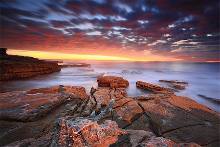 simsearch:400-07667033,k - Simply stunning sunrise long exposure at dawn.   Swift movement in the clouds as they swept in fast.  The warm sunrise light highlighting the clouds and the colours in the rocks and enhancing the warm orange tones. Stock Photo - Budget Royalty-Free & Subscription, Code: 400-08861272