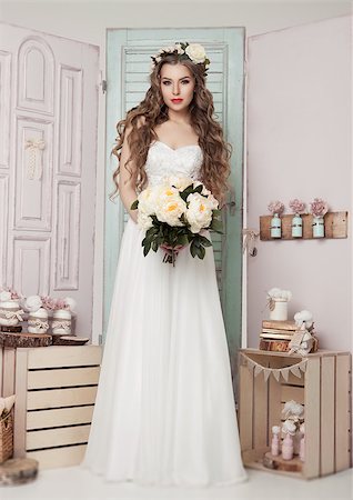 simsearch:400-04762831,k - Beautiful young bride with flowers  romantic decoration pink and green. Wooden boxes bottles and different wedding decoration Stock Photo - Budget Royalty-Free & Subscription, Code: 400-08861677