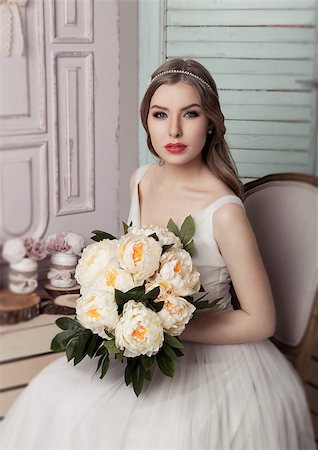 simsearch:400-04762831,k - Beautiful young bride with flowers  romantic decoration pink and green. Wooden boxes bottles and different wedding decoration Stock Photo - Budget Royalty-Free & Subscription, Code: 400-08861682