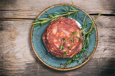 simsearch:400-06082979,k - Dry Sausage with fresh herbs on a plate. Top view Photographie de stock - Aubaine LD & Abonnement, Code: 400-08861894