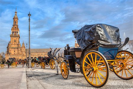 Parked Horse drawn carriages at Plaza de Espana in Seville, Andalusia, Spain. Spain Square Stockbilder - Microstock & Abonnement, Bildnummer: 400-08862561