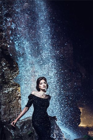 Beautiful woman in black dress posing near waterfall Stock Photo - Budget Royalty-Free & Subscription, Code: 400-08862799