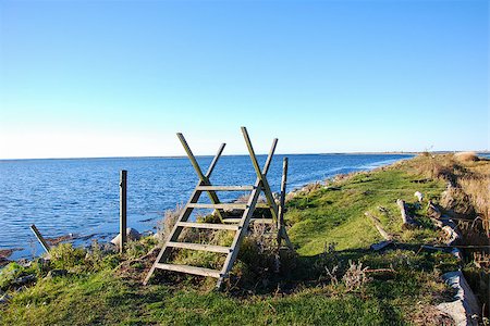 estilo - Coastal wooden stile by a footpath along the coast with calm blue water at the swedish island Oland Stock Photo - Budget Royalty-Free & Subscription, Code: 400-08863112