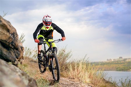 simsearch:400-09084281,k - Professional Cyclist Riding the Bike at the Rocky Trail. Extreme Sport Concept. Free Space for Text. Fotografie stock - Microstock e Abbonamento, Codice: 400-08863220