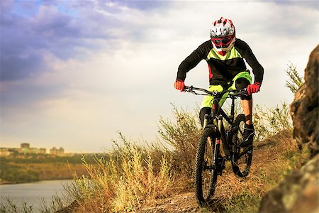 simsearch:400-09084281,k - Professional Cyclist Riding the Bike at the Rocky Trail. Extreme Sport Concept. Free Space for Text. Fotografie stock - Microstock e Abbonamento, Codice: 400-08863221
