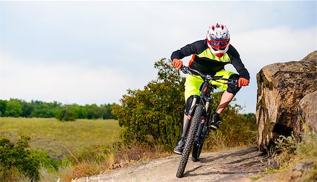 simsearch:400-09084281,k - Professional Cyclist Riding the Bike at the Rocky Trail. Extreme Sport Concept. Free Space for Text. Fotografie stock - Microstock e Abbonamento, Codice: 400-08863222