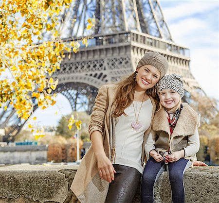 simsearch:400-09031587,k - Autumn getaways in Paris with family. Portrait of happy mother and child tourists on embankment in Paris, France sitting on the parapet Stock Photo - Budget Royalty-Free & Subscription, Code: 400-08863315