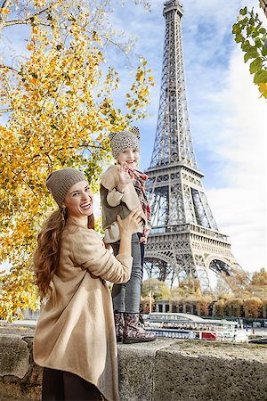 fall pictures of paris - Autumn getaways in Paris with family. Portrait of smiling mother and child travellers on embankment near Eiffel tower in Paris, France handwaving Stock Photo - Budget Royalty-Free & Subscription, Code: 400-08863317