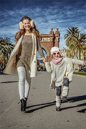 simsearch:400-08864986,k - in Barcelona for a perfect winter. Full length portrait of happy trendy mother and daughter near Arc de Triomf in Barcelona, Spain walking Stock Photo - Budget Royalty-Free & Subscription, Code: 400-08863326