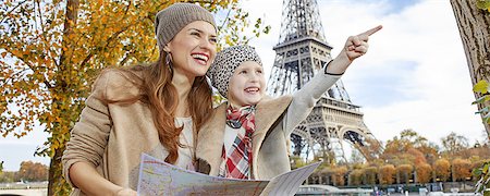 simsearch:400-09031587,k - Autumn getaways in Paris with family. Portrait of happy mother and daughter tourists on embankment in Paris, France holding map and pointing Stock Photo - Budget Royalty-Free & Subscription, Code: 400-08863344