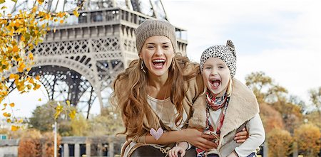 simsearch:400-09031587,k - Autumn getaways in Paris with family. Portrait of smiling mother and child tourists on embankment in Paris, France having fun time Stock Photo - Budget Royalty-Free & Subscription, Code: 400-08863349