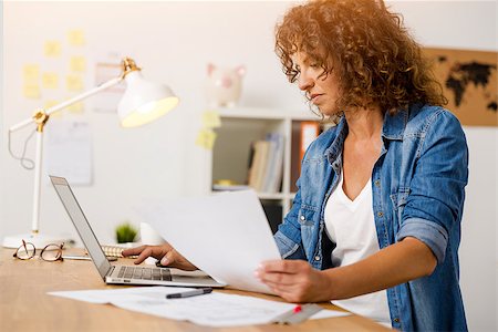 simsearch:400-08613671,k - Middle age woman working at the office Stock Photo - Budget Royalty-Free & Subscription, Code: 400-08863379