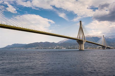 Cable-stayed suspension bridge crossing Corinth Gulf strait, Greece. It is one of the world's longest multi-span cable-stayed bridges and the longest of the fully suspended type Stock Photo - Budget Royalty-Free & Subscription, Code: 400-08863473