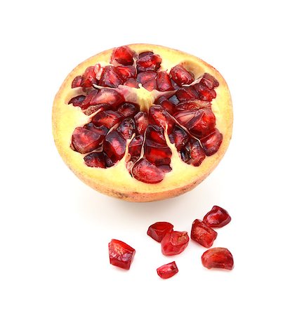 simsearch:640-02656973,k - Cut half pomegranate cross section with seeds removed and spilled on white background Fotografie stock - Microstock e Abbonamento, Codice: 400-08863997