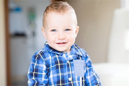 adorable toddler with blue eyes smiling and enjoying time at home Photographie de stock - Aubaine LD & Abonnement, Code: 400-08887694