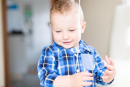 adorable toddler with blue eyes smiling, playing with balloon and enjoying time at home Photographie de stock - Aubaine LD & Abonnement, Code: 400-08887692