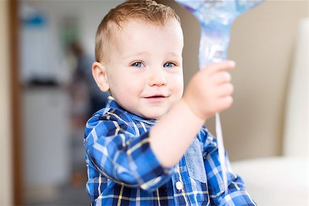 adorable toddler with blue eyes smiling, playing with balloon and enjoying time at home Photographie de stock - Aubaine LD & Abonnement, Code: 400-08887693