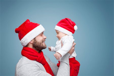 simsearch:400-09222788,k - Father with his baby boy wearing Santa hats celebrating Christmas Photographie de stock - Aubaine LD & Abonnement, Code: 400-08887826